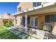 Charming covered patio with a grill, seating area and manicured artificial grass at 9469 Coral Shine Ct, Las Vegas, NV 89123