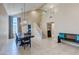 Open-concept dining area with a large wooden table, modern light fixtures, and staircase access at 9469 Coral Shine Ct, Las Vegas, NV 89123