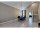 Dining room with a long table, chairs, modern lighting, and an open view of the kitchen and staircase at 9469 Coral Shine Ct, Las Vegas, NV 89123