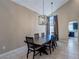 Dining area with large table and modern lighting, complemented by a view into the adjacent kitchen at 9469 Coral Shine Ct, Las Vegas, NV 89123