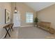 Inviting entryway with vaulted ceilings, stylish light fixture, console table and wooden bench seating at 9469 Coral Shine Ct, Las Vegas, NV 89123