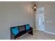 Welcoming entryway with a decorative front door, a bench with accent pillows, and a stylish overhead light at 9469 Coral Shine Ct, Las Vegas, NV 89123