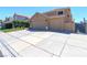 Exterior view of the house featuring a three-car garage and well-maintained landscaping at 9469 Coral Shine Ct, Las Vegas, NV 89123