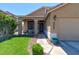 Charming front yard with lush landscaping, a walkway leading to the porch, and a well-maintained lawn at 9469 Coral Shine Ct, Las Vegas, NV 89123
