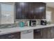 Elegant kitchen showcasing dark cabinets, white countertops, and mosaic tile backsplash at 9469 Coral Shine Ct, Las Vegas, NV 89123