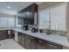 Stylish kitchen featuring dark cabinets, stainless appliances, and bright, natural light at 9469 Coral Shine Ct, Las Vegas, NV 89123