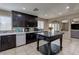 Spacious kitchen featuring dark wood cabinetry, stainless appliances, and a center island at 9469 Coral Shine Ct, Las Vegas, NV 89123