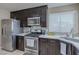 Well-equipped kitchen with stainless steel appliances, granite countertops, and ample storage at 9469 Coral Shine Ct, Las Vegas, NV 89123