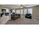 Open living room with neutral tones, carpet, and view into kitchen area at 9469 Coral Shine Ct, Las Vegas, NV 89123