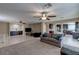 Expansive living room area with modern furnishings, a ceiling fan, and seamless flow into the kitchen at 9469 Coral Shine Ct, Las Vegas, NV 89123