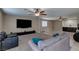 Spacious living room features a TV, ceiling fans, and opens to an area with tile flooring at 9469 Coral Shine Ct, Las Vegas, NV 89123