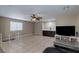 Spacious living room features neutral tile flooring, a ceiling fan, and a built-in bar area at 9469 Coral Shine Ct, Las Vegas, NV 89123