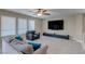Cozy living room with a ceiling fan, a large TV, and comfortable seating on plush carpeting at 9469 Coral Shine Ct, Las Vegas, NV 89123