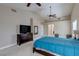 The primary bedroom features neutral walls, vaulted ceilings, and sleek dark dressers at 9469 Coral Shine Ct, Las Vegas, NV 89123
