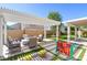 Outdoor patio area with a pergola, comfortable seating, and artificial grass at 9469 Coral Shine Ct, Las Vegas, NV 89123