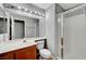 Bathroom showcasing a vanity, mirror, toilet, and glass enclosed shower with tile surround at 10135 Diving Duck Ave, Las Vegas, NV 89117