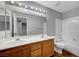 Bathroom boasts double sinks, modern fixtures, a bathtub, and a large mirror at 10135 Diving Duck Ave, Las Vegas, NV 89117
