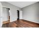 Bedroom showcasing hardwood floors, a closet, and doorway access to an attached bathroom at 10135 Diving Duck Ave, Las Vegas, NV 89117