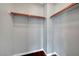 Empty closet with shelving and wood support rods for ample storage solutions at 10135 Diving Duck Ave, Las Vegas, NV 89117