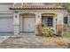 Inviting entryway with double doors, decorative columns, and drought-resistant landscaping at 10135 Diving Duck Ave, Las Vegas, NV 89117