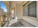 Covered front porch with decorative columns and a smooth concrete walkway at 10135 Diving Duck Ave, Las Vegas, NV 89117