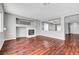 Bright living room with hardwood floors, a fireplace, and an open design connecting to other spaces at 10135 Diving Duck Ave, Las Vegas, NV 89117