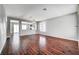 Spacious living room featuring gleaming hardwood floors, neutral paint, and abundant natural light at 10135 Diving Duck Ave, Las Vegas, NV 89117