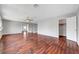 Living room featuring hardwood floors, ceiling fan, and open access to other rooms at 10135 Diving Duck Ave, Las Vegas, NV 89117