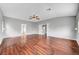Open living area featuring hardwood floors, a ceiling fan, and multiple doorways at 10135 Diving Duck Ave, Las Vegas, NV 89117