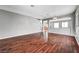 Open-concept living area boasting hardwood floors, neutral paint, and seamless flow to other rooms at 10135 Diving Duck Ave, Las Vegas, NV 89117