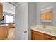 Powder room with bright sink and vanity plus access to the large kitchen at 10135 Diving Duck Ave, Las Vegas, NV 89117