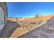 Desert landscaping in backyard, enclosed by a brick wall, offers a low-maintenance outdoor space at 1048 Forrest Falcon Dr, Henderson, NV 89011