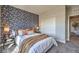 Comfortable bedroom featuring an accent wall, bedside tables, and access to the en-suite bath at 1048 Forrest Falcon Dr, Henderson, NV 89011