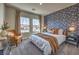 Cozy bedroom with a large window, warm colors, and comfortable furnishings at 1048 Forrest Falcon Dr, Henderson, NV 89011
