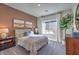 Serene bedroom with a decorative mirror, carpet floors, and warm, inviting colors at 1048 Forrest Falcon Dr, Henderson, NV 89011