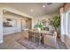 Bright dining area featuring neutral tones, a large window, and an open transition into the living space at 1048 Forrest Falcon Dr, Henderson, NV 89011
