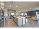 Open-concept kitchen featuring a large island, modern appliances, and a seamless flow into the living area at 1048 Forrest Falcon Dr, Henderson, NV 89011