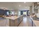 Spacious kitchen with an island featuring barstool seating, modern appliances, and an open layout to the living room at 1048 Forrest Falcon Dr, Henderson, NV 89011