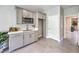 An efficient kitchenette featuring gray cabinetry and stainless steel appliances and adjacent doorway at 1048 Forrest Falcon Dr, Henderson, NV 89011