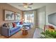Inviting living room with a blue sofa, wall art, and a TV for relaxation and entertainment at 1048 Forrest Falcon Dr, Henderson, NV 89011