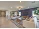 Welcoming living space with a stylish accent wall, abundant natural light, and a comfortable seating arrangement at 1048 Forrest Falcon Dr, Henderson, NV 89011