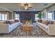 Symmetrical living room design with stylish furniture, elegant decor, and a modern entertainment center at 1048 Forrest Falcon Dr, Henderson, NV 89011