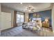 Tastefully decorated bedroom featuring a large window, stylish furnishings, and a textured accent wall at 1048 Forrest Falcon Dr, Henderson, NV 89011