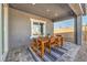 Relaxing covered patio with dining set, perfect for outdoor meals and entertaining guests at 1048 Forrest Falcon Dr, Henderson, NV 89011