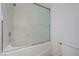 Bathroom featuring a shower and bathtub combo with glass doors and a white toilet at 10525 Pine Glen Ave # 206, Las Vegas, NV 89144