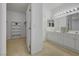 Bathroom features dual sinks with bright lighting and a closet for extra storage at 10525 Pine Glen Ave # 206, Las Vegas, NV 89144