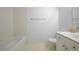 Bathroom featuring a bathtub, white toilet, white tile walls and a single sink at 10525 Pine Glen Ave # 206, Las Vegas, NV 89144