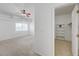 This bedroom features a large window, ceiling fan, and a walk-in closet with white shelving at 10525 Pine Glen Ave # 206, Las Vegas, NV 89144
