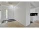 Neutral entryway with black tiled foyer leads to a light and airy kitchen at 10525 Pine Glen Ave # 206, Las Vegas, NV 89144