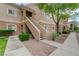 Condo exterior with stairs to the front door, attractive desert landscaping at 10525 Pine Glen Ave # 206, Las Vegas, NV 89144